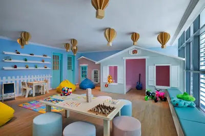 a childs play room with a table and a play set at NH Collection Dubai The Palm in Dubai