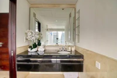 a bathroom with a sink and a large mirror at Welcome Home at The Address Marina 1BR in Dubai