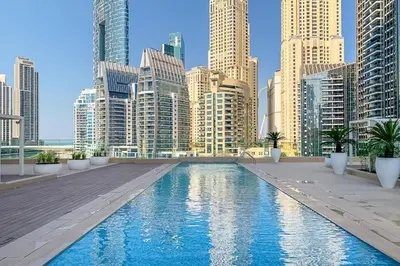 a pool in the middle of a city with tall buildings at Stella Maris, Dubai Marina - Mint Stay in Dubai