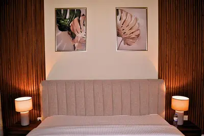 a bedroom with a bed with three pictures on the wall at Perfect 1 Bedroom Boulevard,Fountain & Opera View in Dubai