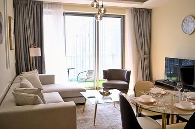 a living room with a couch and a table at Perfect 1 Bedroom Boulevard,Fountain & Opera View in Dubai