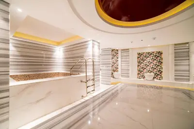 a lobby with a swimming pool in a building at Vacay Lettings - Waterfront Studio with great Dubai Canal view in Dubai