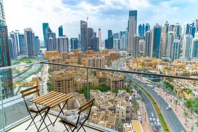 a balcony with a table and chairs and a city at Holidays R Us Royal View in Dubai