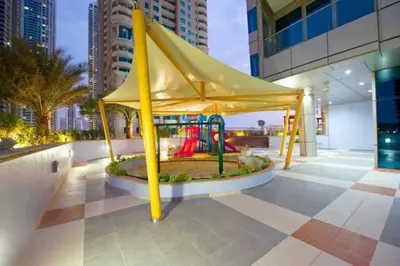 a playground in the middle of a building at Ocean Heights - Spacious 1 Bedroom Apartment with Sea View, Gym & Free Parking in Dubai