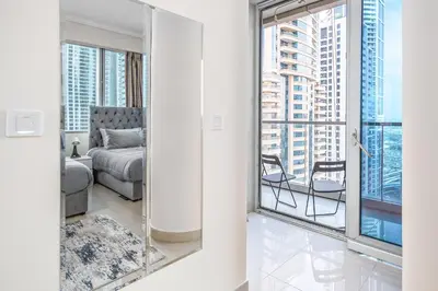 a bedroom with a view of a bed and a window at Breathtaking sea-view condo in Dubai Marina - Palm Views! in Dubai