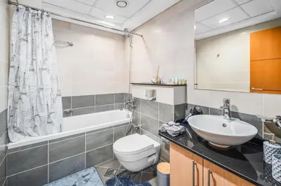 a bathroom with a sink and a toilet and a tub at Breathtaking sea-view condo in Dubai Marina - Palm Views! in Dubai