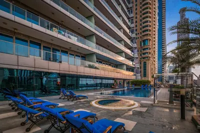 a group of blue chairs in front of a building at Breathtaking sea-view condo in Dubai Marina - Palm Views! in Dubai