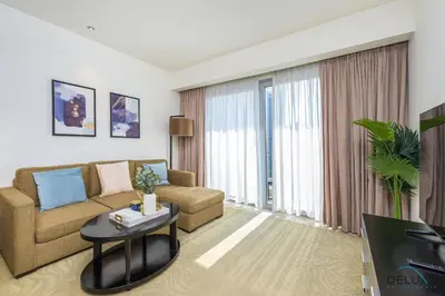 a living room with a couch and a table at Ornate 1BR in The Address Residences Dubai Marina by Deluxe Holiday Homes in Dubai