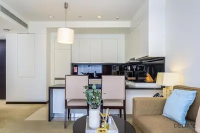 a kitchen and living room with a couch and a table at Ornate 1BR in The Address Residences Dubai Marina by Deluxe Holiday Homes in Dubai