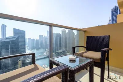a balcony with a chair and a table with a view at Ornate 1BR in The Address Residences Dubai Marina by Deluxe Holiday Homes in Dubai