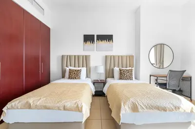 a bedroom with two beds and a mirror at Beautiful Sea and Marina View - Premium 2BR in JBR in Dubai