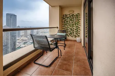 a balcony with a table and chairs and a view at Spacious 2BD in Amwaj JBR near the beach in Dubai