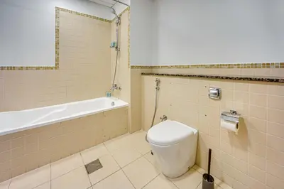a bathroom with a toilet and a bath tub at Spacious 2BD in Amwaj JBR near the beach in Dubai