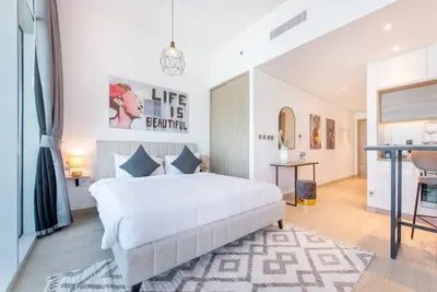 a bedroom with a large white bed in a room at Funky STUDIO Dubai Marina outstanding facilities in Dubai