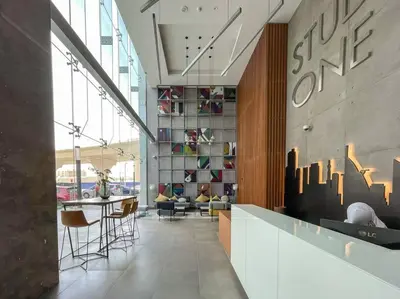a lobby with a table and chairs in a building at Funky STUDIO Dubai Marina outstanding facilities in Dubai