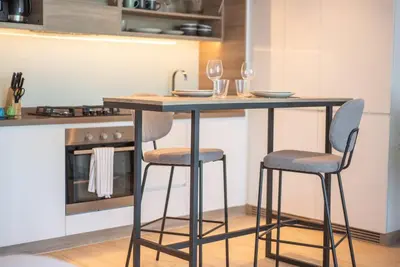 a kitchen with a island with two bar stools at Funky STUDIO Dubai Marina outstanding facilities in Dubai