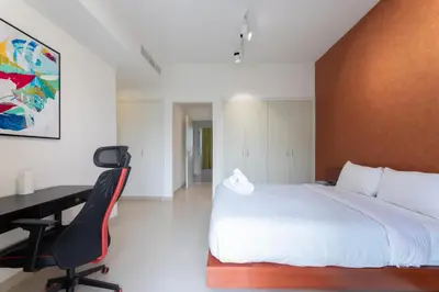 a bedroom with a bed and a desk and a computer at Stunning 4 bedroom townhouse in Townsquare in Dubai