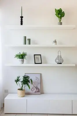 a white living room with plants on shelves at Frank Porter - Al Sidir 2 in Dubai
