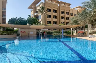 a swimming pool in front of a building at Frank Porter - Al Sidir 2 in Dubai