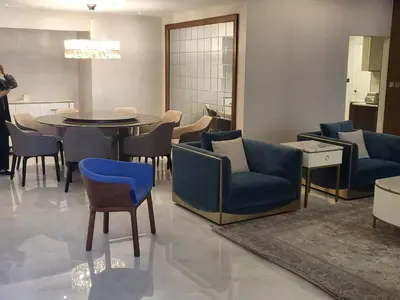 a living room with blue chairs and a table at USMANS 5 BEDROOM APARTMENT at JBR WALK RIMAL ON THE BEACH 2750 SFT HUGE Direct Beach Access Fully Serviced JBR in Dubai