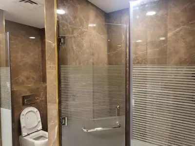 a bathroom with a toilet and a glass shower at USMANS 5 BEDROOM APARTMENT at JBR WALK RIMAL ON THE BEACH 2750 SFT HUGE Direct Beach Access Fully Serviced JBR in Dubai