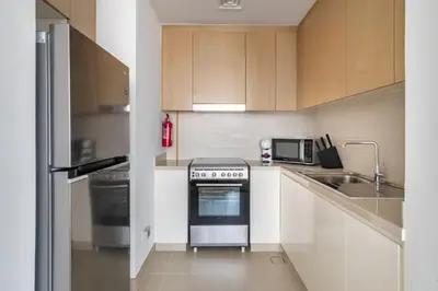 a small kitchen with a stove and a sink at GuestReady - Contemporary with Ain Dubai View in Dubai
