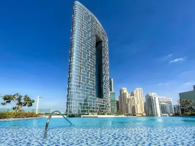 a tall building with a pool in front of a city at GuestReady - Contemporary with Ain Dubai View in Dubai