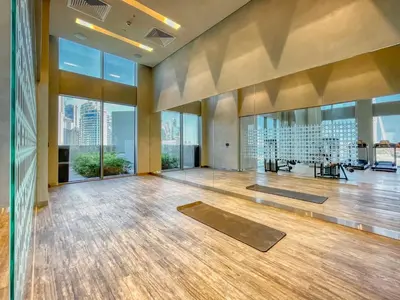 a gym with yoga mats in a large room with windows at GuestReady - Contemporary with Ain Dubai View in Dubai