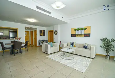 a living room with a couch and a table at Luxury Escapes - Palm Jumeirah's Spectacular Ocean-View Apartment - NABAT in Dubai