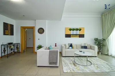 a living room with two white couches and a table at Luxury Escapes - Palm Jumeirah's Spectacular Ocean-View Apartment - NABAT in Dubai