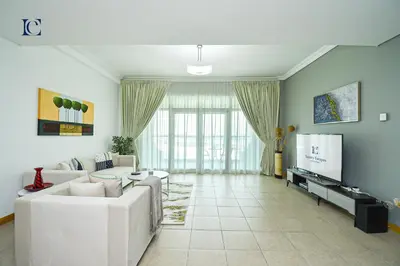 a living room with white furniture and a flat screen tv at Luxury Escapes - Palm Jumeirah's Spectacular Ocean-View Apartment - NABAT in Dubai