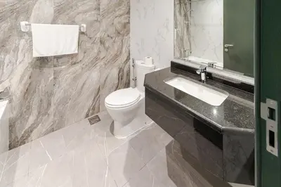 a bathroom with a white toilet and a sink at Spacious Studio I Close to Dubai Canal in Dubai