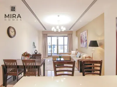 a living room with a couch and a table at Mira Holiday Homes - Furnished 1 bedroom in Heart of Dubai in Dubai