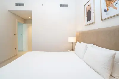 a bedroom with a large bed with white pillows at HomesGetaway-Luxury 2Br Apartment in Beach Vista Tower 2 in Dubai
