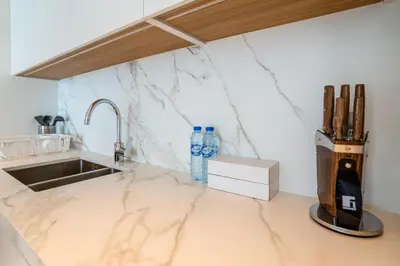a kitchen with a marble counter top and a sink at HomesGetaway-Luxury 2Br Apartment in Beach Vista Tower 2 in Dubai