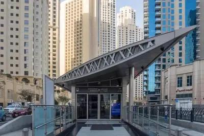 an entrance to a building in a city with tall buildings at 360 Vacation - Spacious 3BR Close to the Beach I Rimal1 JBR in Dubai