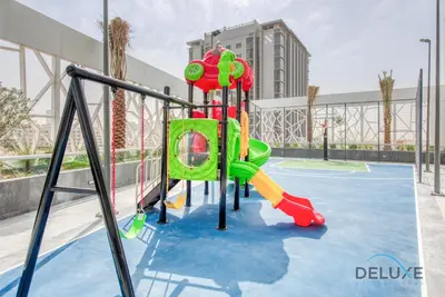 a playground with a slide on a court at Vibrant 1BR in Bella Rose Al Barsha South by Deluxe Holiday Homes in Dubai