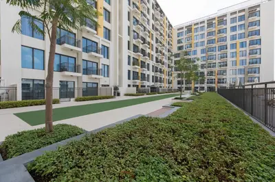 an empty sidewalk in front of a building at BNew Chic 1BR Apt Near Trump Golf w Pool and Gym in Dubai