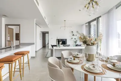 a white living room with a table and chairs at Frank Porter - Stella Maris in Dubai
