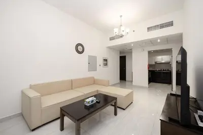 a living room with a couch and a table at Stylish 4BR with Jacuzzi, Sauna & Prime Amenities in Dubai