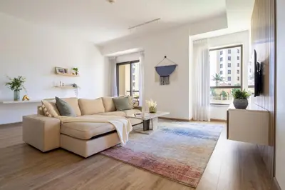 a living room with a couch and a table at Frank Porter - Rimal 1 in Dubai