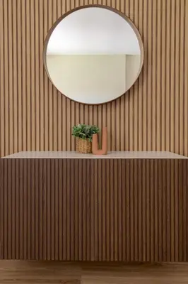 a mirror on a wall with a plant on a shelf at Frank Porter - Rimal 1 in Dubai