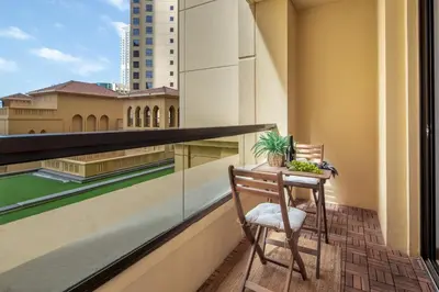 a chair sitting on a balcony with a view at Frank Porter - Rimal 1 in Dubai