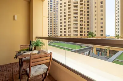 a balcony with a table and a view of buildings at Frank Porter - Rimal 1 in Dubai