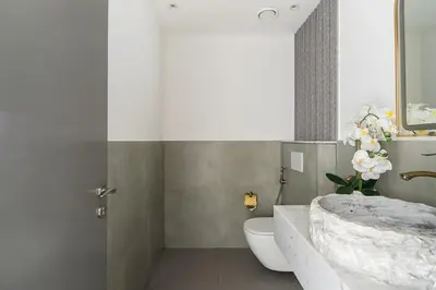 a bathroom with a tub and a toilet and a sink at Frank Porter - Rimal 1 in Dubai