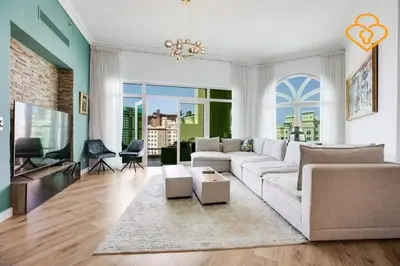 a living room with a white couch and a tv at Keysplease Upgraded 3 B/R + Nanny Beach Access, Palm Jumeirah in Dubai