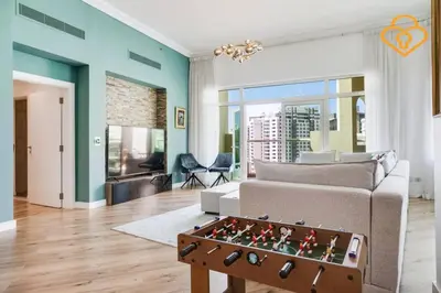 a living room with a couch and a chess board on a table at Keysplease Upgraded 3 B/R + Nanny Beach Access, Palm Jumeirah in Dubai