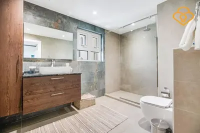 a bathroom with a toilet and a sink and a mirror at Keysplease Upgraded 3 B/R + Nanny Beach Access, Palm Jumeirah in Dubai