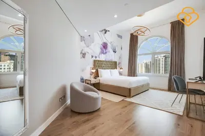 a bedroom with a bed and a desk and a chair at Keysplease Upgraded 3 B/R + Nanny Beach Access, Palm Jumeirah in Dubai