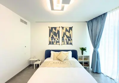 a bedroom with a large bed with a blue headboard at Unique 1BR in Stella Maris,City View,Dubai Marina in Dubai